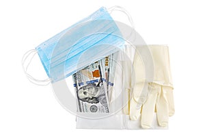 Medical sterile rubber gloves, blue medical face mask and stack of 100 USD banknotes. Isolated on white