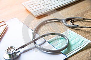 medical stethoscope check heart near a laptop on a wooden table