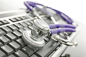 Medical stethoscope on computer keyboard