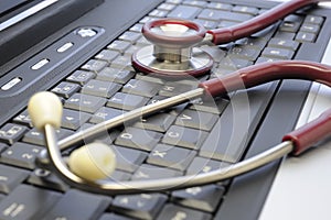 medical stethoscope and computer keyboard