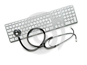 Medical stethoscope on computer keyboard.