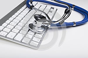 Medical stethoscope on computer keyboard. Concept of computer support.