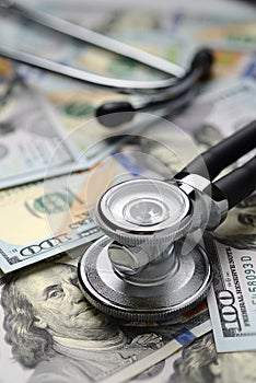 Medical stethoscope and dollar bills