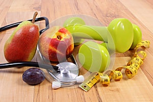 Medical stethoscope, fruits and dumbbells for using in fitness