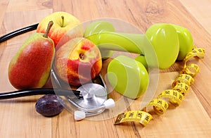 Medical stethoscope, fruits and dumbbells for using in fitness