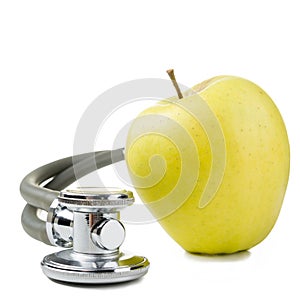 Medical stethoscope with green apple isolated on white backgroun