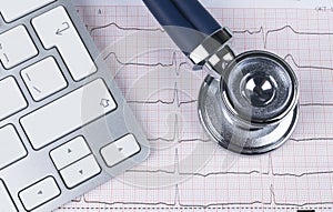 Medical stethoscope lying on cardiogram chart computer keyboard. Cardiology care health protection prevention, help. Healthy life