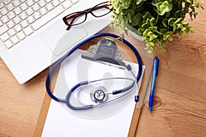 Medical stethoscope lying on a computer keyboard