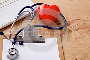 Medical stethoscope lying on a computer keyboard