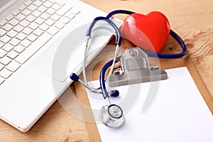 Medical stethoscope lying on a computer keyboard