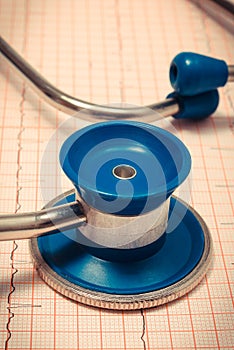 Medical stethoscope lying on electrocardiogram graph report. Healthy lifestyles