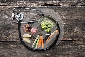 Medical stethoscope making a loop around a healthy vegan snack