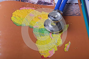 Medical stethoscope on a map, at the desk