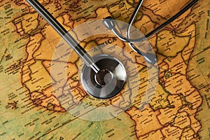 Medical stethoscope over africa healthcheck. close-up map