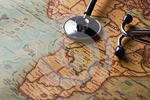 Medical stethoscope over Africa healthcheck. close-up map