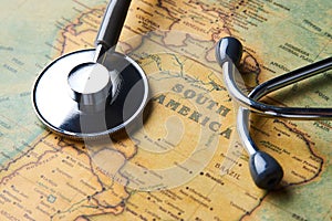 Medical stethoscope over South America healthcheck. close-up