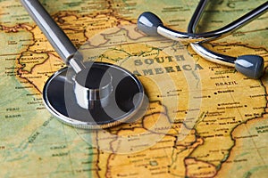 Medical stethoscope over South America healthcheck. close-up