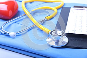 Medical stethoscope, patient medical history list, RX prescription, red heart and blue doctor uniform closeup. Medical