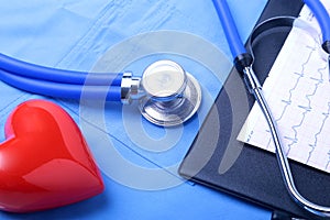 Medical stethoscope, patient medical history list, RX prescription, red heart and blue doctor uniform closeup. Medical