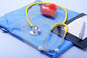 Medical stethoscope, patient medical history list, RX prescription, red heart and blue doctor uniform closeup. Medical