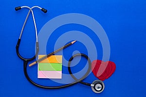 Medical Stethoscope with a pencil and sticky notes.