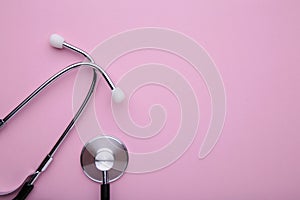 Medical stethoscope on a pink background. Health care concept