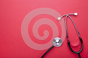 Medical stethoscope on a red background. Health care concept