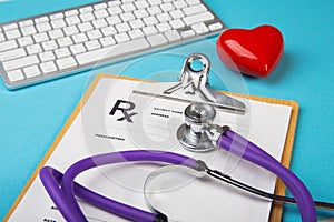 Medical stethoscope and red heart lying on cardiogram chart closeup. Medical help, prophylaxis, disease prevention or