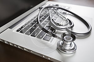 Medical Stethoscope Resting on Laptop Computer