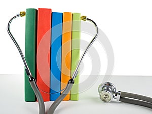 Medical stethoscope and stack of books. Medical professional edu