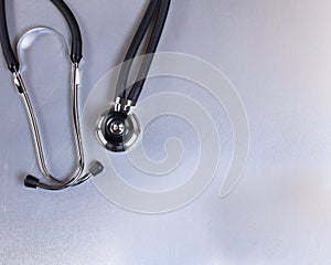 Medical stethoscope on stainless steel table