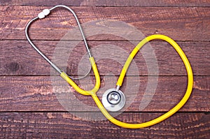 Medical stethoscope and tablets isolated on wooden background