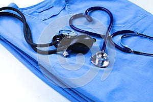 Medical stethoscope twisted in heart shape lying on patient medical history list and blue doctor uniform closeup