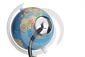 Medical stethoscope wrapped around globe