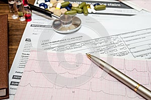 Medical still life with patient health information, cardiogram, pills, stethoscope