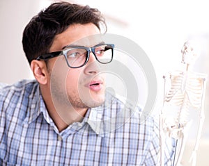 Medical student studing the skeleton