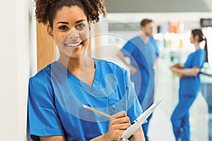 Medical student taking notes in hallway