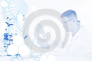 Medical student working in modern scientific laboratory and graphic DNA strand