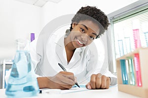 medical student writing notes for research