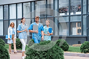 medical students and lecturer walking on street