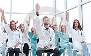 Medical students raising their hands during the seminar.