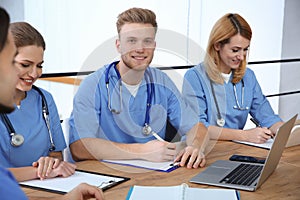 Medical students in uniforms studying