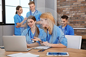 Medical students in uniforms studying
