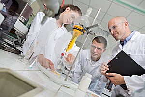 Medical students working with microscope at university