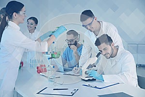 Medical students working in scientific laboratory, color tone
