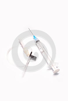 Medical syringe closeup with catheter on white background isolated