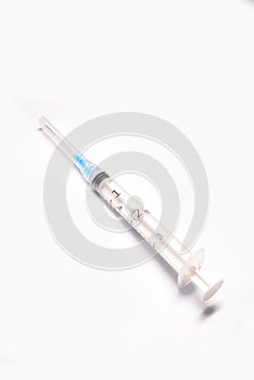 Medical syringe closeup on white background isolated