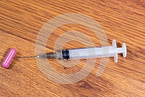 Medical syringe and drugs on a table close-up. Drug addiction.