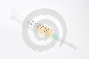 A medical syringe filled with medicine or a drug on a white background.