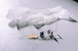 Medical syringe and gloves on a white background